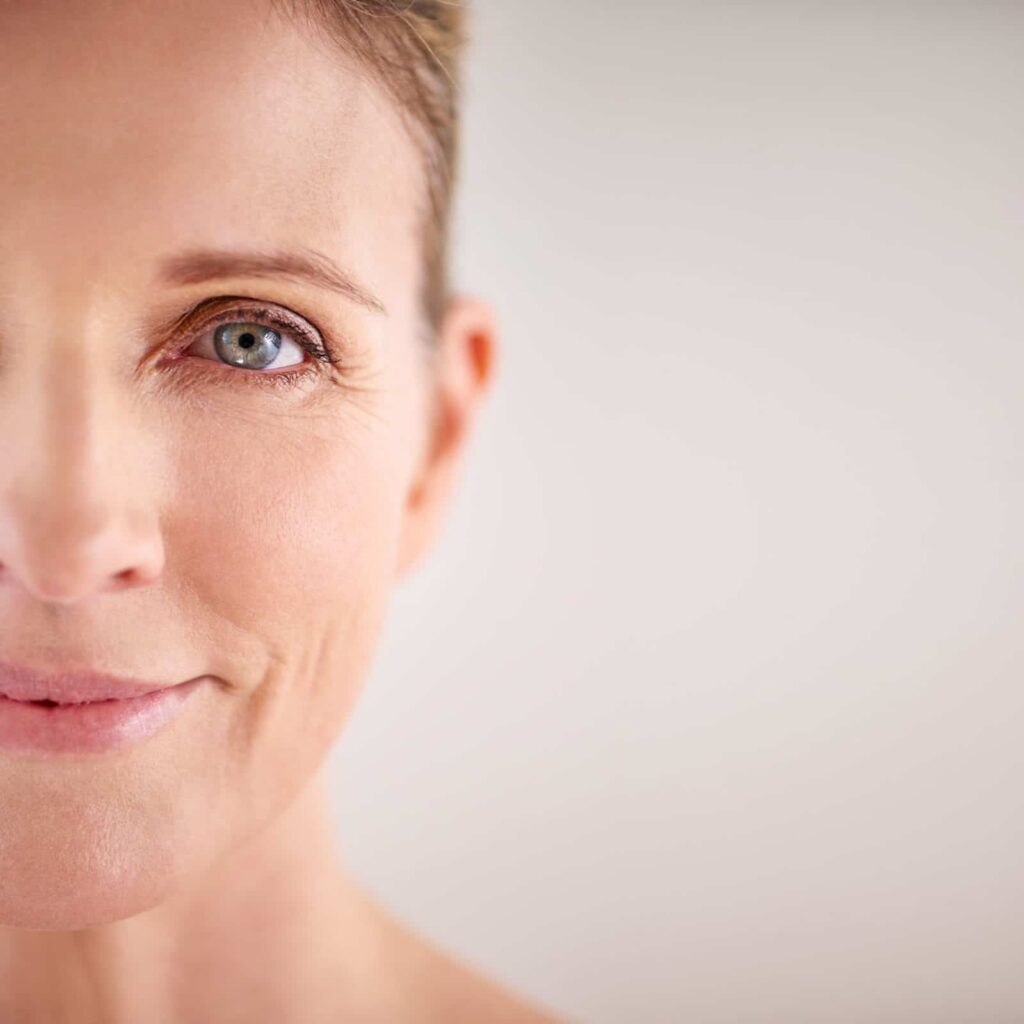 Closeup of a woman's face with beige background