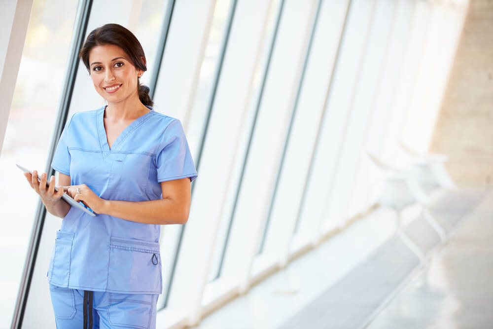 Nurse looking at digital device