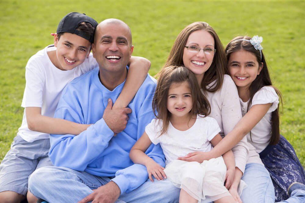 Smiling family with three young children