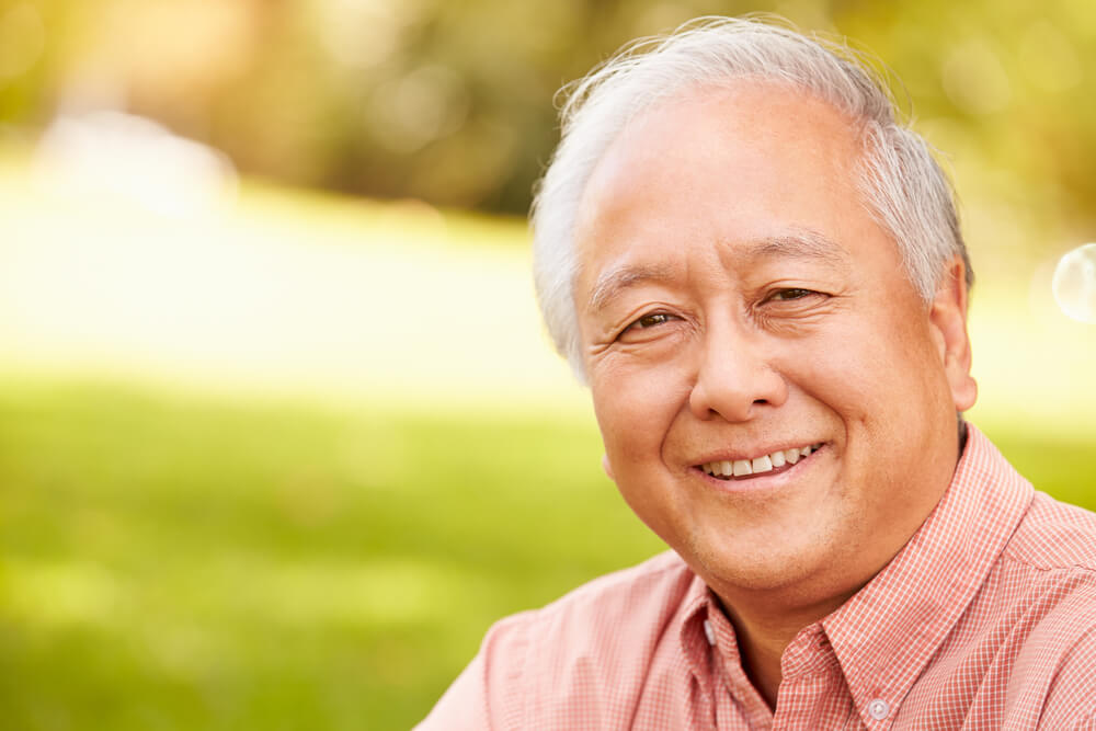 Smiling older man outside